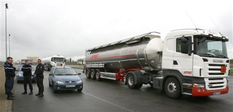A full tanker truck leaves a fuel depot near the oil refinery of Donges, western France, on Saturday. The refinery remains closed but police cleared access to the fuel depot. Travelers in France are facing another day of spotty train service and gas shortages as strikes against the government's pension reform enter their twelfth straight day. 